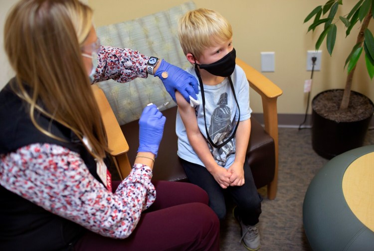 FALMOUTH, ME - NOVEMBER 3: Neal Zimmerman, 6, of Brunswick receives a covid shot from Kate Sawyer, RN, at Maine Medical Partners Falmouth Pediatrics on Wednesday. (Photo by Derek Davis/Staff Photographer)