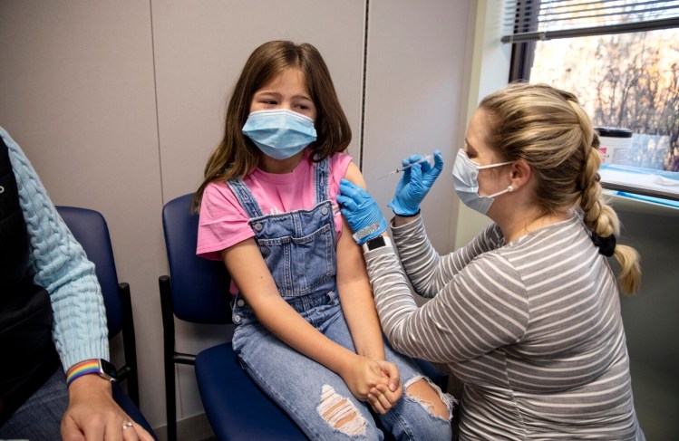 Crystal Smith gives Molly Richard, 10, her first dose of the Pfizer vaccine at an InterMed vaccine clinic on Saturday. Molly's mother, Maggie Zamboni, is a pediatrician at InterMed. Molly said she was excited to get the vaccine to help protect her grandparents from COVID-19 as well as her friends who have asthma.