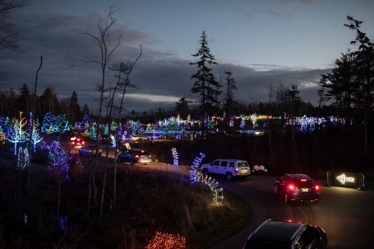 Spectators make their way through a driving tour of Gardens Aglow  in November at the Coastal Maine Botanical Gardens in Boothbay. 