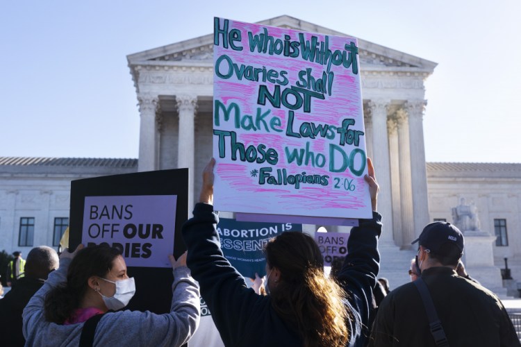 Ava Stevenson, 20, left, of Montgomery County, Md., rallies for abortion rights with her mother, Jenni Coopersmith, center, outside the Supreme Court on  Monday as arguments  about abortion were set to begin before the court, on Capitol Hill in Washington. 