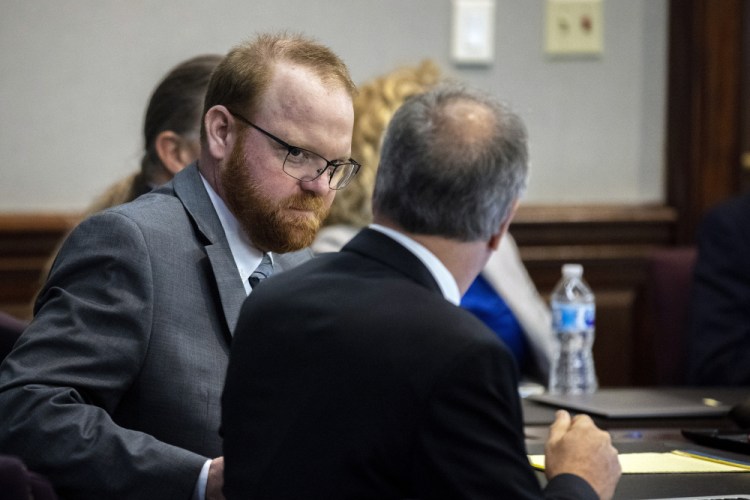 Defendant Travis McMichael, shown  speaking with his attorney Bob Rubin while they wait for the jury to return to the courtroom on Wednesday, was convicted of murder in the killing of Ahmaud Arbery. Also convicted were Travis McMichael's father, Greg McMichael, and a neighbor, William "Roddie" Bryan, in the Glynn County Courthouse in Brunswick, Ga. 