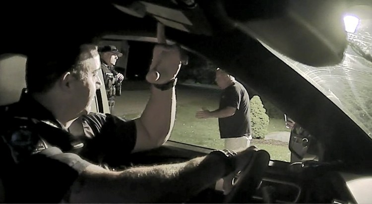Captured last July 20 on police video, former South Berwick police Chief Dana Lajoie, right, tells Berwick police Sgt. Jeff Pilkington, center, that Berwick police officers who drove onto his private road were trespassing. The Lajoies tried to press charges against police for driving briefly down the road.


