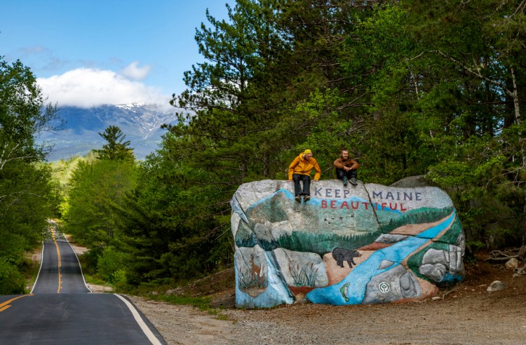 Jackson Parell of Florida, left, and Sammy Potter of Maine spend time atop an iconic hand-painted rock the day before they climbed Mount Katahdin to complete the Appalachian Trail on May 27, 2021, in Baxter State Park, Maine. (Gina Ferazzi/Los Angeles Times/TNS)