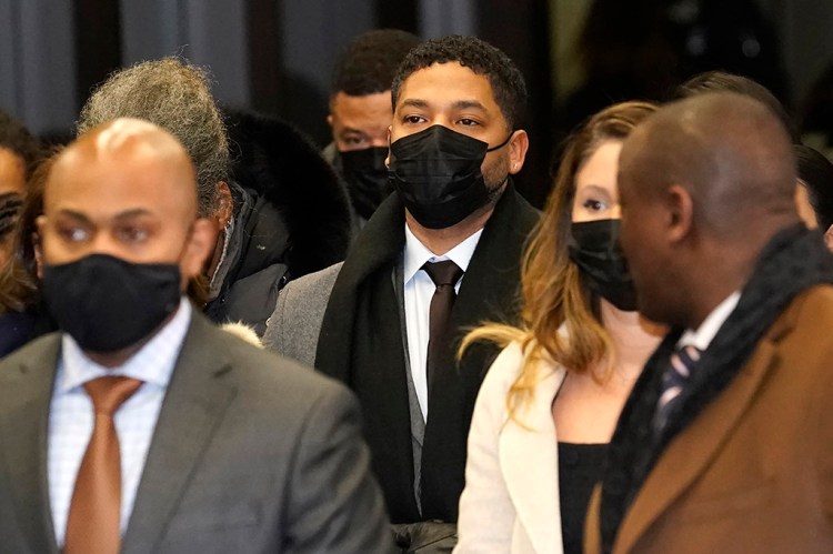 Actor Jussie Smollett, center, returns to the Leighton Criminal Courthouse, Thursday, Dec. 9, 2021, in Chicago, after the jury notified Cook County Judge James Linn that they have reached a verdict in Smollett's trial. (AP Photo/Charles Rex Arbogast)