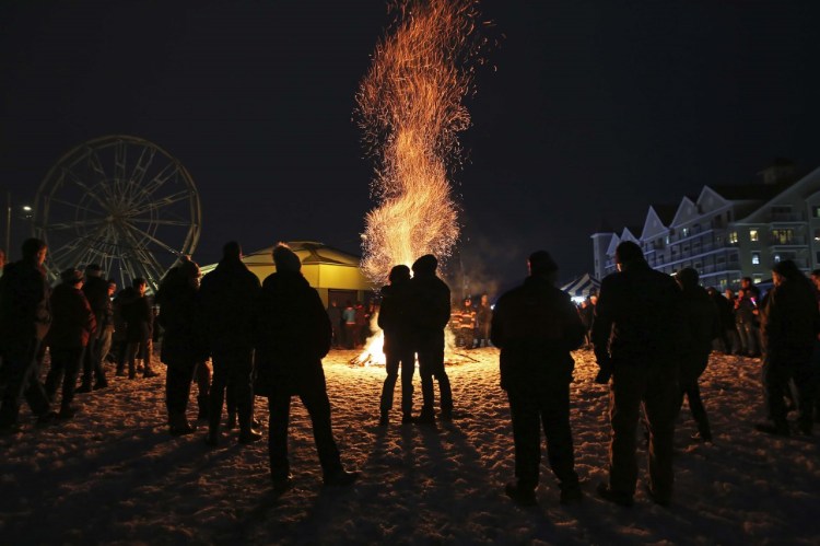 A bonfire made of donated Christmas trees is the centerpiece for the Last Blast New Year’s Eve Beach Party held by OOB365. Jill Brady/Staff Photographer

 