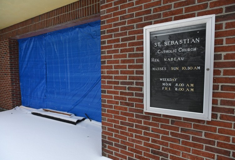 3353# 01crash MADISON, MAINE  Damage the front on St. Sebastian Catholic  Church is covered in a tarp in Madison, Maine Monday January 17, 2022. The damage was caused when a vehicle hit the building. (Rich Abrahamson/Morning Sentinel)