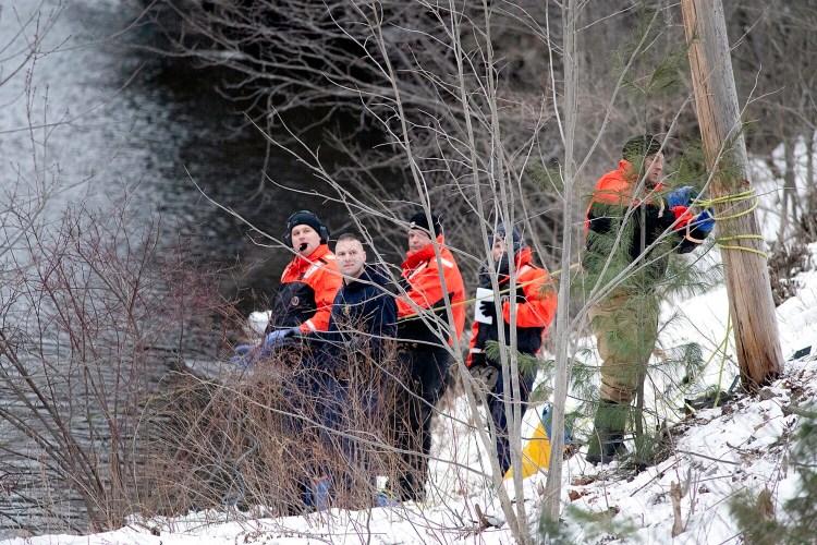 Underwater recovery team personnel tend to lines attached to underwater divers Monday in the Little Androscoggin River in Auburn.