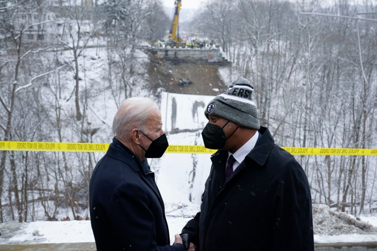 President Biden shakes hands with Pittsburgh Mayor Ed Gainey as he visits the site where the Fern Hollow Bridge collapsed Friday in Pittsburgh's East End. 
