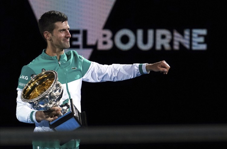 Serbia's Novak Djokovic holds the Norman Brookes Challenge Cup after defeating Russia's Daniil Medvedev in the men's singles final at the Australian Open tennis championship in Melbourne, Australia, in February. Djokovic has had his visa canceled and been denied entry to Australia on Thursday. 