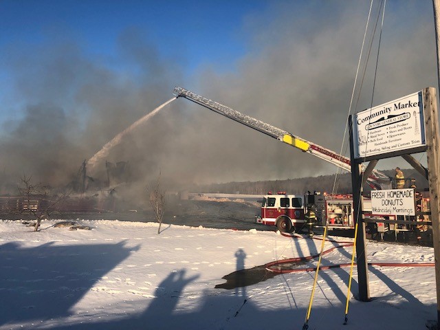 Firefighters douse hot spots Thursday following a fire that destroyed the Community Market and Bakery at 368 Thorndike Road in Unity.