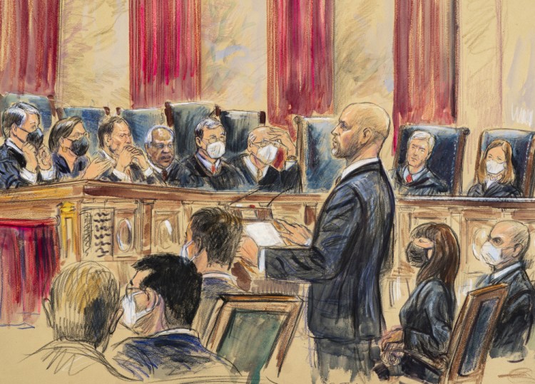 This artist sketch depicts lawyer Scott Keller standing to argue on behalf of more than two dozen business groups seeking an immediate order from the Supreme Court to halt a Biden administration order to impose a vaccine-or-testing requirement on the nation's large employers, at the Supreme Court in Washington on Friday. Solicitor General Elizabeth Prelogar, the Biden administration's top Supreme Court lawyer, is seated at right. 