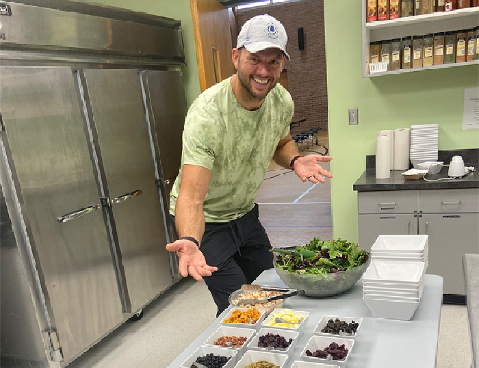 Former NFL player Jared Veldheer with one of his salad bars this month at Saint Paul the Apostle Catholic School in Grand Rapids, Mich. CREDIT: Photo courtesy of Katie Tietema