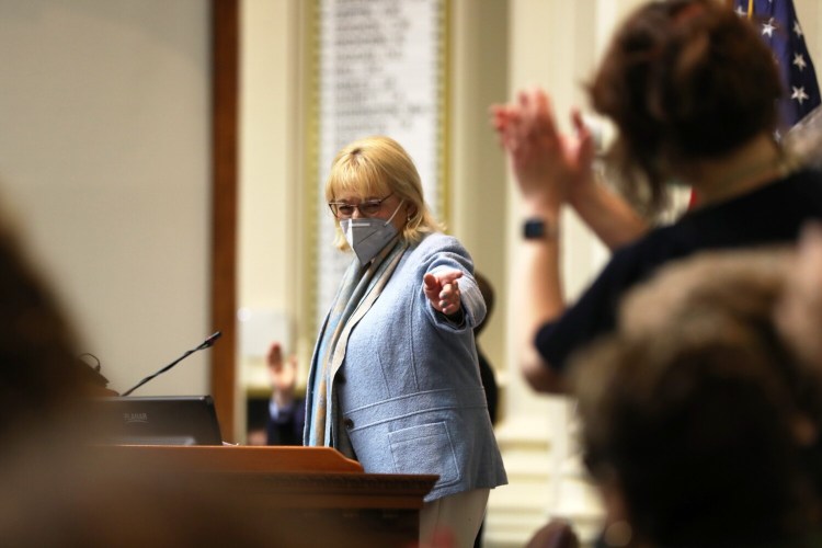 Gov. Janet Mills receives a standing ovation from Democrats during her State of the State Address on Feb. 10.