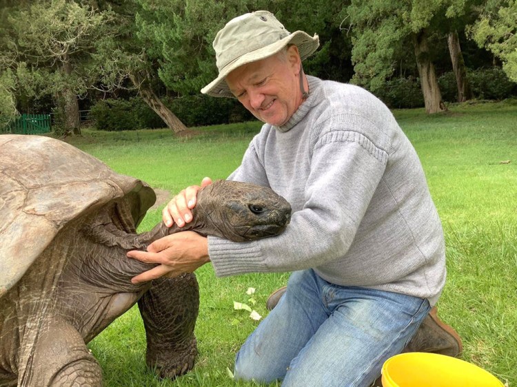 Jonathan the tortoise, 190, and his caretaker, Joe Hollins, 64, on St. Helena island. MUST CREDIT: Tina Lucy