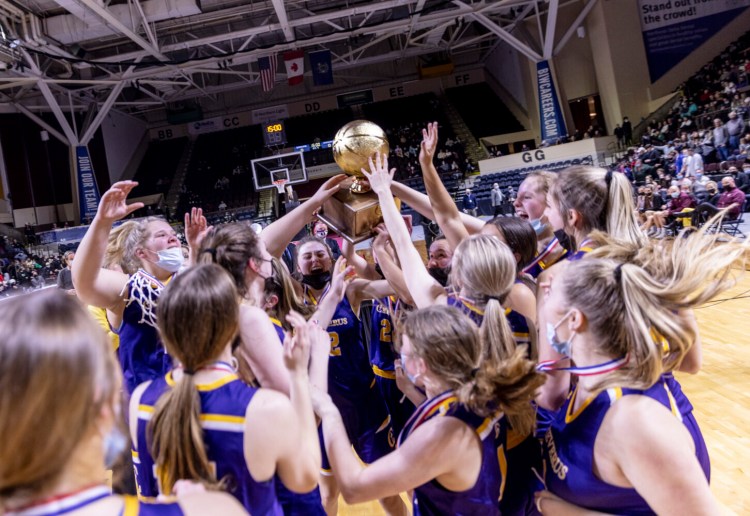 Cheverus celebrates with the Gold Ball after winning the program's first state title.