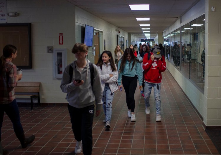 Old Orchard Beach High School students walk to their morning classes Wednesday, the first day that the school no longer required the students or staff to wear masks. 