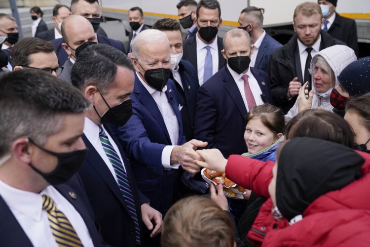 President Joe Biden meets with Ukrainian refugees and humanitarian aid workers during a visit to PGE Narodowy Stadium, Saturday in Warsaw. 