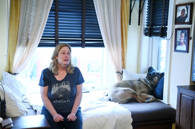 Arianne Bennett in her Northwest D.C. apartment. Her husband, Scott Bennett, in the photo at top right, died of covid-19 in January. He was fully vaccinated and boosted. MUST CREDIT: Washington Post photo by Matt McClain
