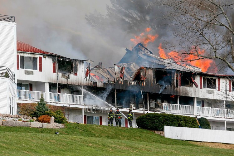 Firefighters battle the flames roaring through the south wing of the Red Jacket Mountain View Resort in North Conway, N.H., on Saturday, April 30, 2022.  (Rachel Sharples/Conway Daily Sun via AP)
