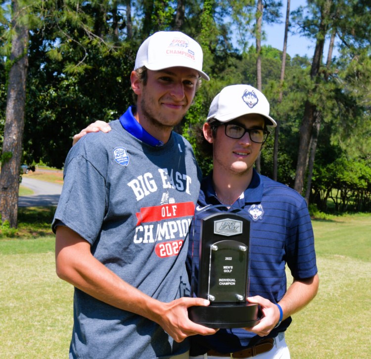 University of Connecticut golfer Caleb Manuel, right, holds the Big East Conference Championship trophy with Gregor Tait of Seton Hall. Manuel is the first medalist for the Huskies at the event since 1994.