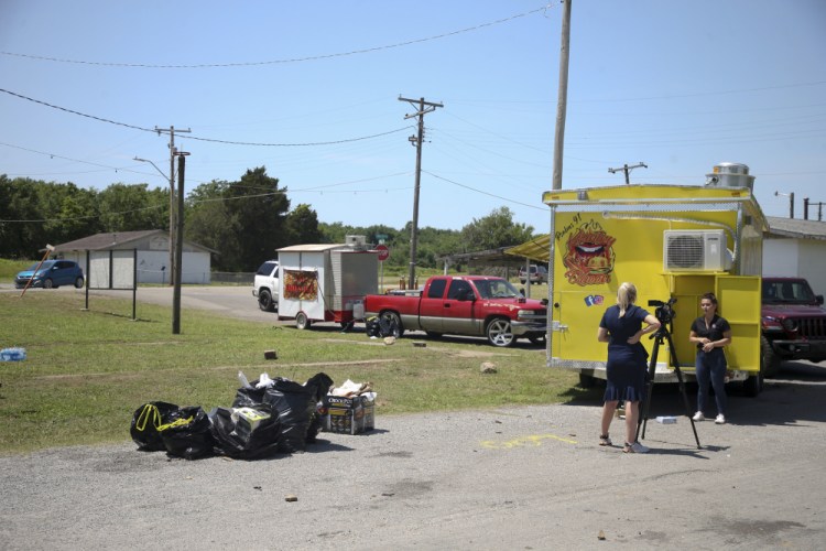 News crews film at the scene of a fatal shooting Sunday in Taft, Okla.