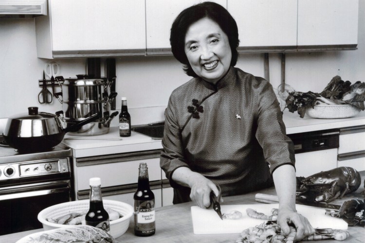 Chen in the kitchen with her branded products - a flat-bottom wok, knife and sauces - in 1984. MUST CREDIT: Courtesy of Stephen Chen.