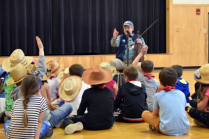 Local fiddler Keith Fletcher fields questions from Wells Elementary Grade 2 students as part of an integrated studies program on the history of the Oregon Trail. Fletcher has participated in the program as a musical performer and educational speaker for 20-plus years.