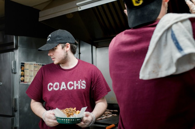 Owen Burke, left, co-owner of Coach's Steak & Hoagie House, with co-owner Eddie Burke, right, in the restaurant's kitchen in Doylestown, Pa. MUST CREDIT: Photo for The Washington Post Hannah Yoon