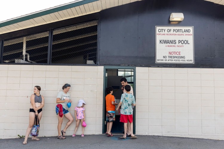 Michael Koharian waits with his two kids Malcolm, 12, and Leland, 10, to get into Kiwanis Community Pool on Sunday. The heatwave in the Northeast continued on Sunday, with temperatures nearing 90 degrees in Portland.