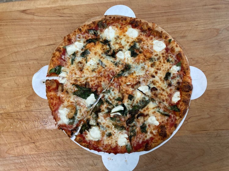 A pizza with spinach, ricotta, garlic and red sauce from  Brickyard Hollow Brewing Company's Portland location. 