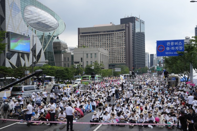 People gather before a rally opposing the Seoul Queer Culture Festival in Seoul, South Korea, Saturday. Thousands of gay rights supporters marched under a heavy police guard in the South Korean capital on Saturday as they celebrated the city's first Pride parade in three years after a COVID-19 hiatus.