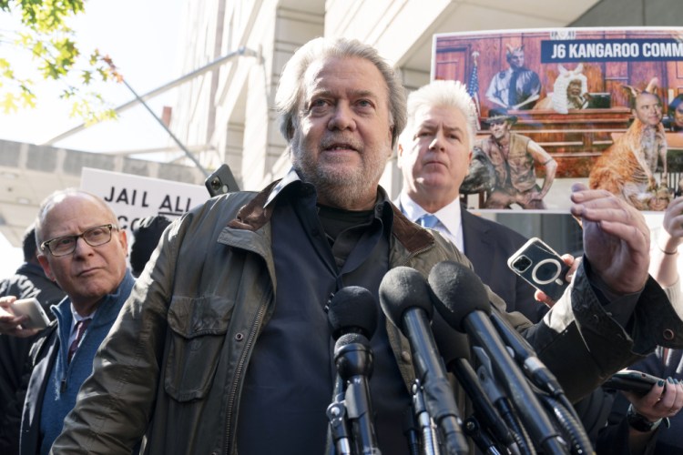 Steve Bannon, center,  accompanied by his attorneys David Schoen, left, and Evan Corcoran, right, speaks to the media as he leaves the federal courthouse on Friday. Bannon was sentenced to 4 months behind bars for defying a Jan. 6 committee subpoena. ( AP Photo/Jose Luis Magana)