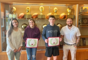 Caption: From left, Wells High School coach Katelyn Rich poses with WHS students Elana Vennard, Ryan Woodward ,and coach Shane Daly. Vennard and Woodward were honored as Student Athlete's of the Month. (Photo courtesy of WHS Athletics Director Jodie Lawlor)