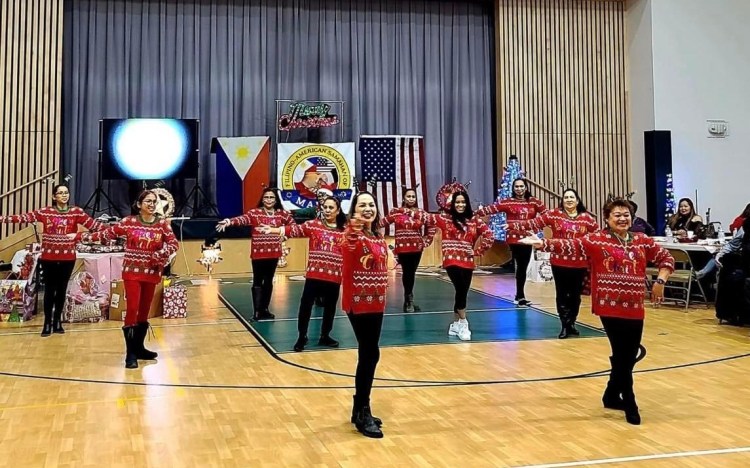 At the Filipino American Samahan of Maine Christmas party at St. John's Community Center in Brunswick, dancers in matching Christmas sweaters did a dance routine to "All I Want for Christmas is You." The party had dance performances, karaoke, games, live music, and, of course, Filipino holiday food. 