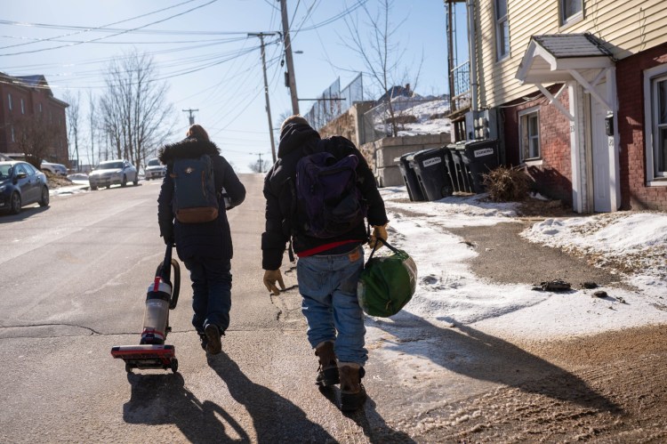 Alex Southworth, right, walks with a friend to a pawn shop on Feb.18 with a vacuum cleaner and a tent that had been donated to them in hopes of pawning them. Southworth is recently homeless and struggling to figure out how to  get back into a better living situation.