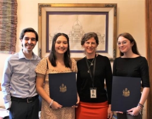 From left, Scarborough High School choral director Jeff Mosher, student Adriana Ramirez, Sen. Stacy Brenner, and SHS student Livie Richard pose during a school outing to the Maine Statehouse