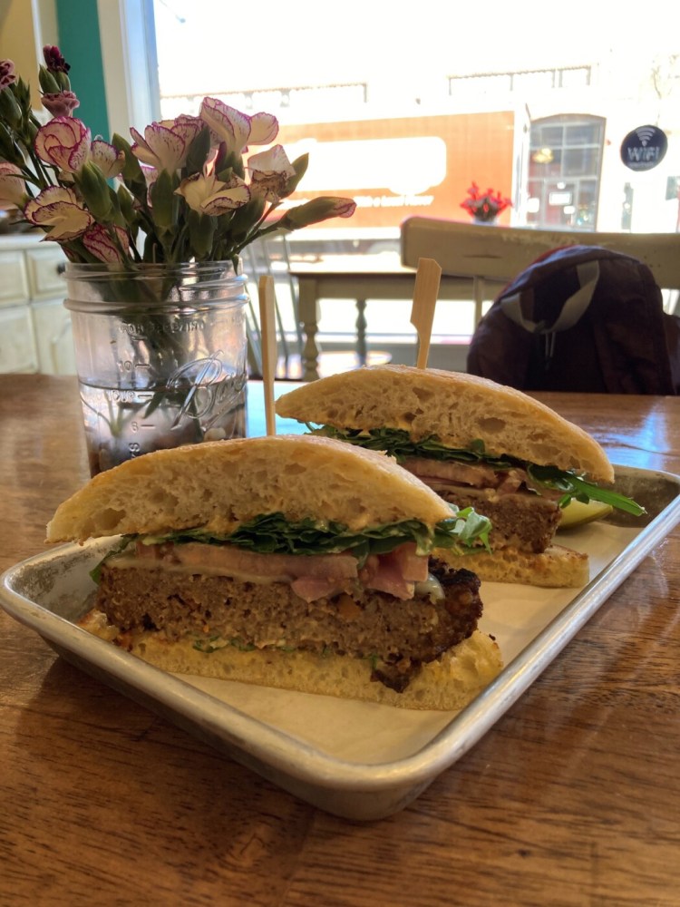 The Not Your Average Joe meatloaf sandwich at Bake Maine Pottery Cafe. Mason jar vases holding fresh flowers sit on every table. 