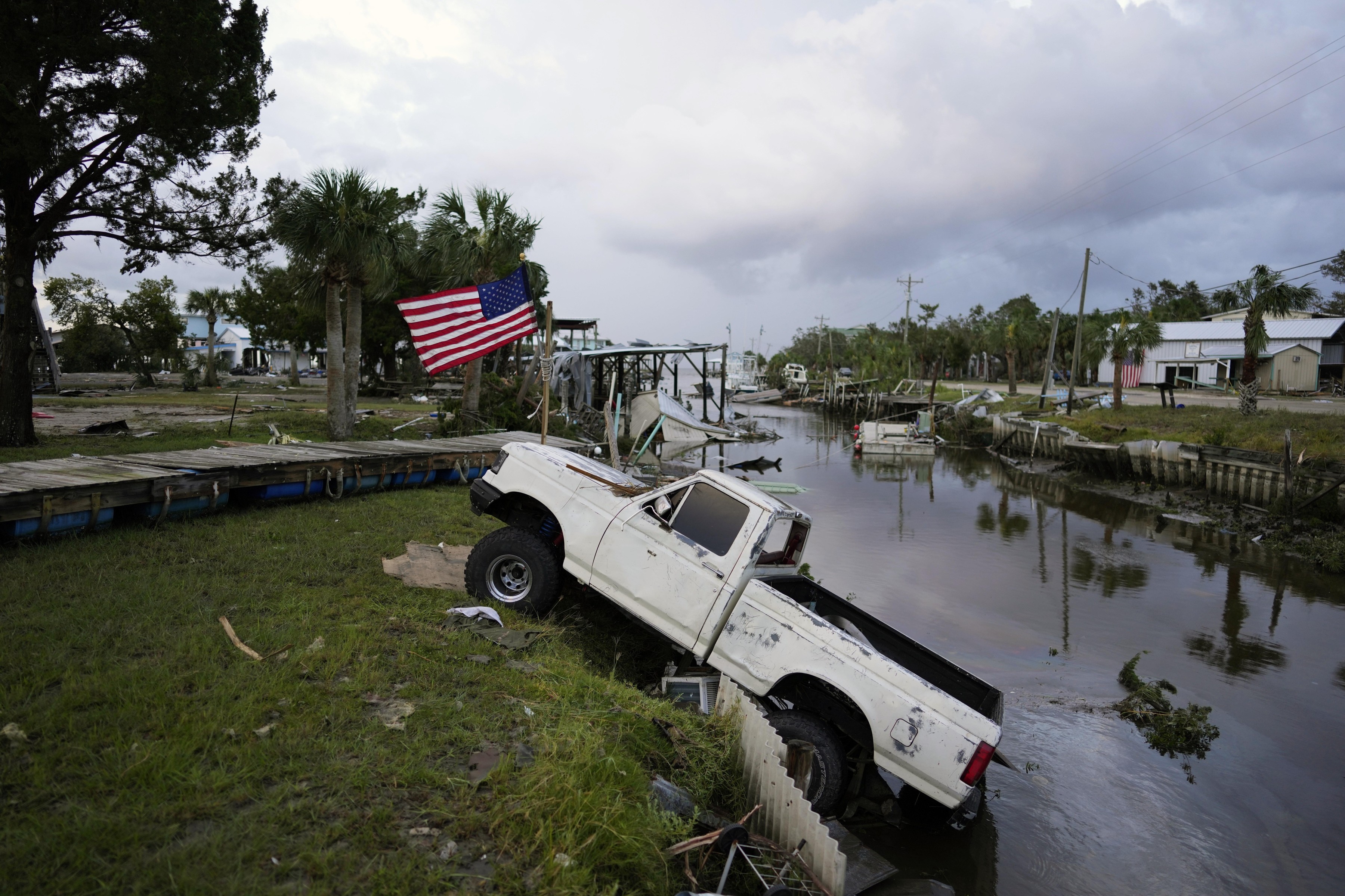 Residents pick through the rubble of lost homes and scattered