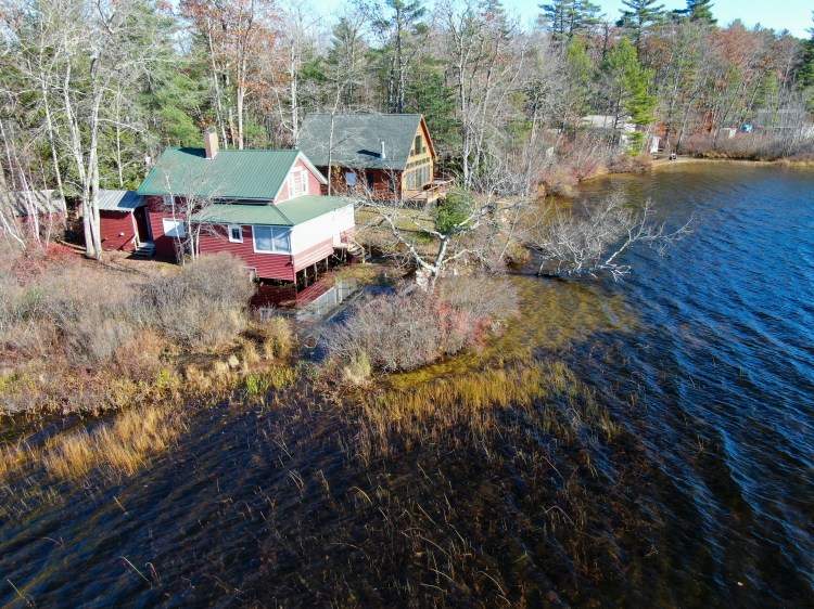 Tripp Pond Aerial photo showing flooding on the Kneeland property on Tripp Pond days before the beaver dam was slowly dismantled in late 2022. Bladders installed by lake association members after the dam was removed raised the water levels back up. Submitted photo