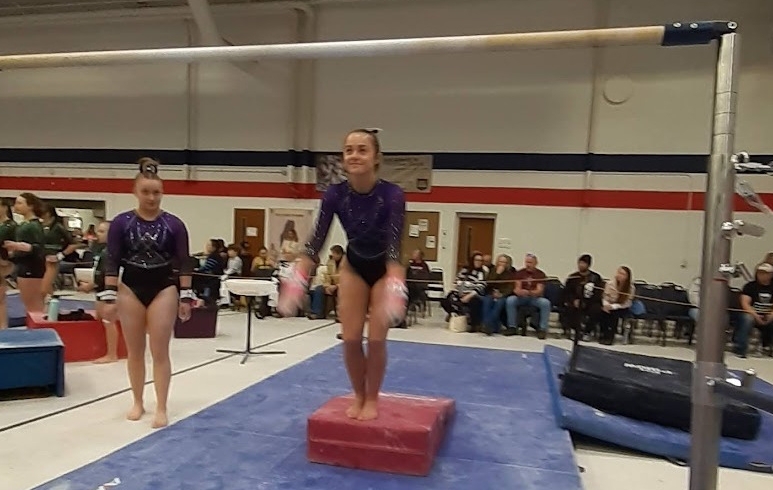 Emily Grover of West Gardiner parpasres to grab the bars at Saturday's Never Give Up Never Quit Invitational gymnastics meet at the Augusta Armory.