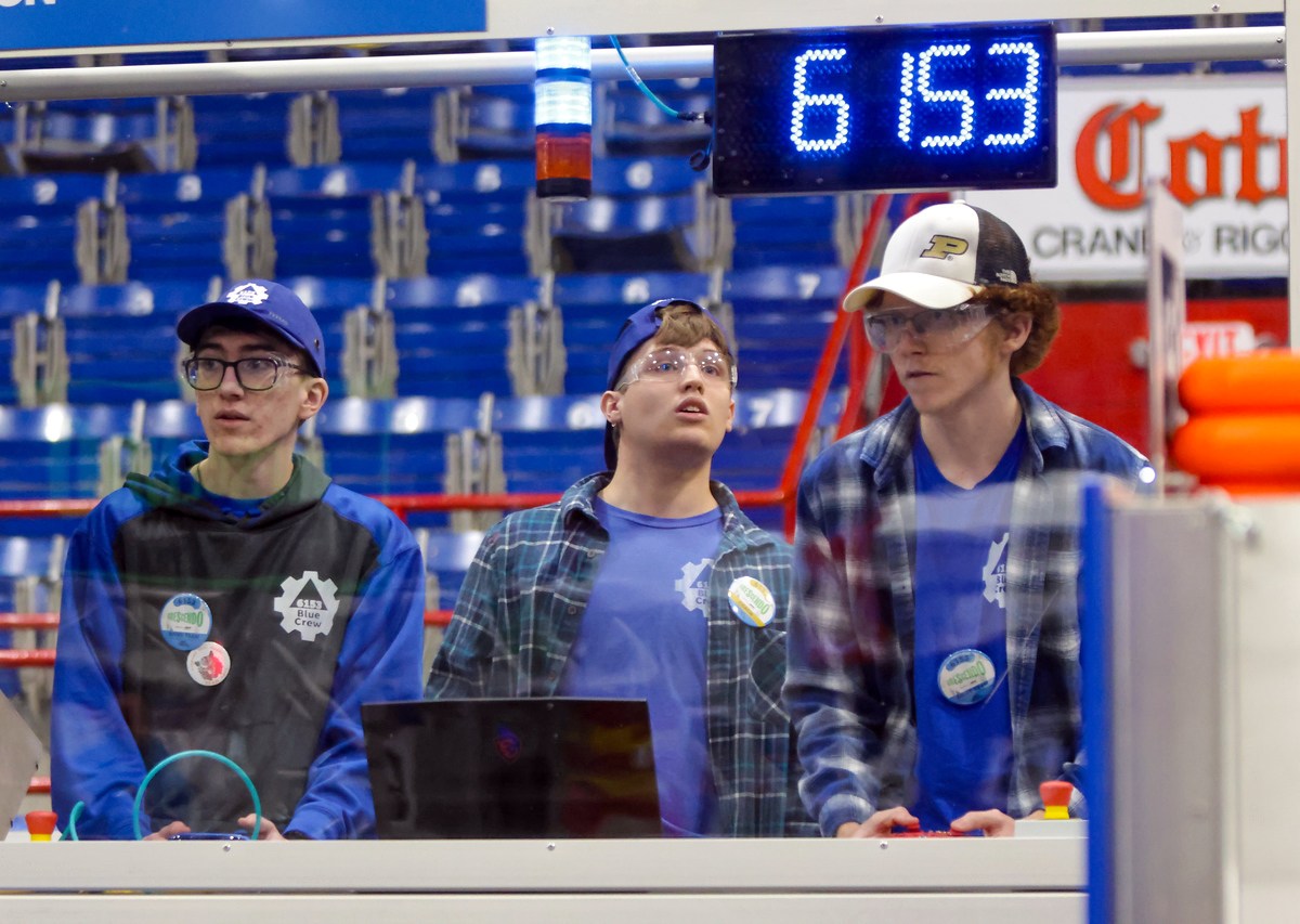 Blue Crew FIRST Robotics Competition Team 6153 auxiliary driver Gentry House at left, drive coach Chandler Pike, and main driver Jack Cramer at right are seen during a recent competition.