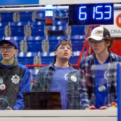 Blue Crew FIRST Robotics Competition Team 6153 auxiliary driver Gentry House at left, drive coach Chandler Pike, and main driver Jack Cramer at right are seen during a recent competition.