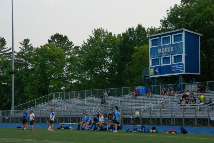 Parents sit in the McMann Field stands as the Morse boys' soccer team scrimmages against Erskine Academy on Tuesday, July 30.