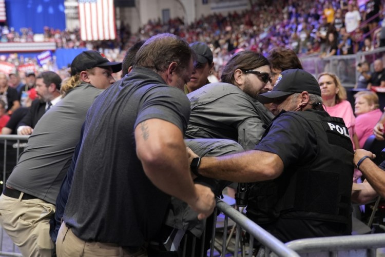 Police say man will face charges after storming press area at Trump rally