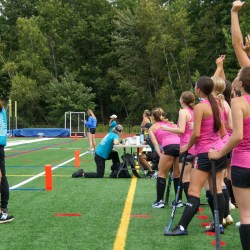 Brunswick head coach Carrie Sullivan turns to her team to celebrate a goal during the 2024 Drive Out Cancer Field Hockey tournament.