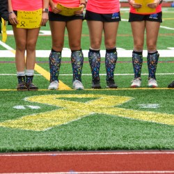 Members of the Mt. Ararat field hockey team wear socks with a ribbon pattern for the 2024 Drive Out Cancer field hockey tournament.