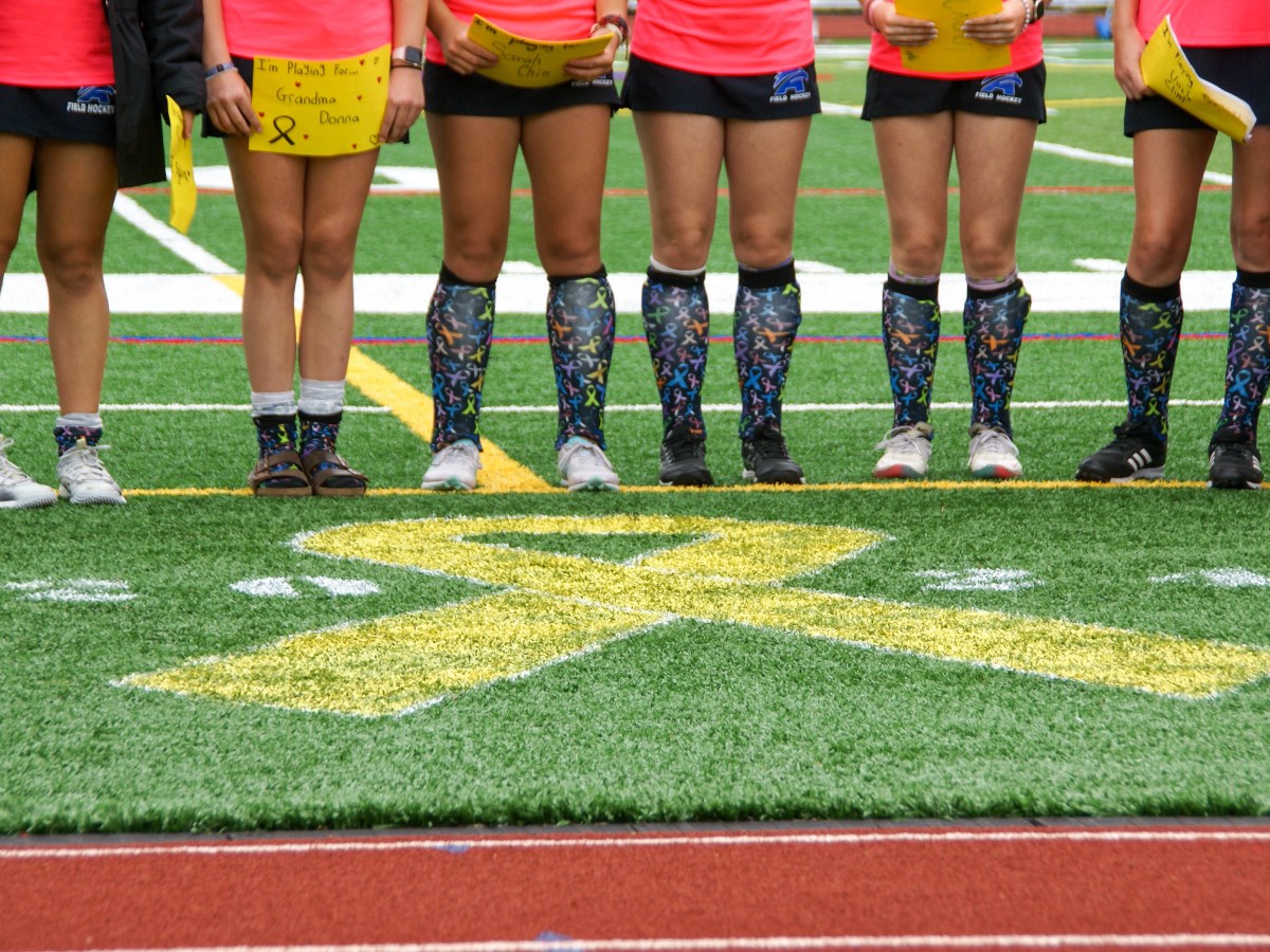 Members of the Mt. Ararat field hockey team wear socks with a ribbon pattern for the 2024 Drive Out Cancer field hockey tournament.