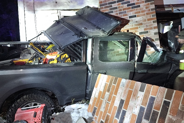 The chimney of a Lovell Road home in Sweden sits atop a truck after a Massachusetts man drove into the home late Wednesday evening.