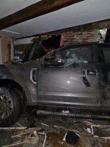 A pickup truck sits partially in a Sweden home after a Massachusetts man drove into the house on Lovell Road late Wednesday evening.